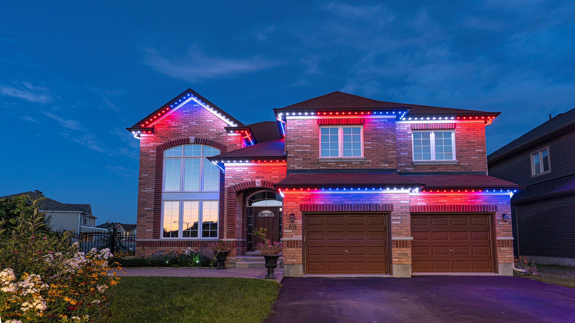 Home with red, white, and blue permanent lighting for the Fourth of July